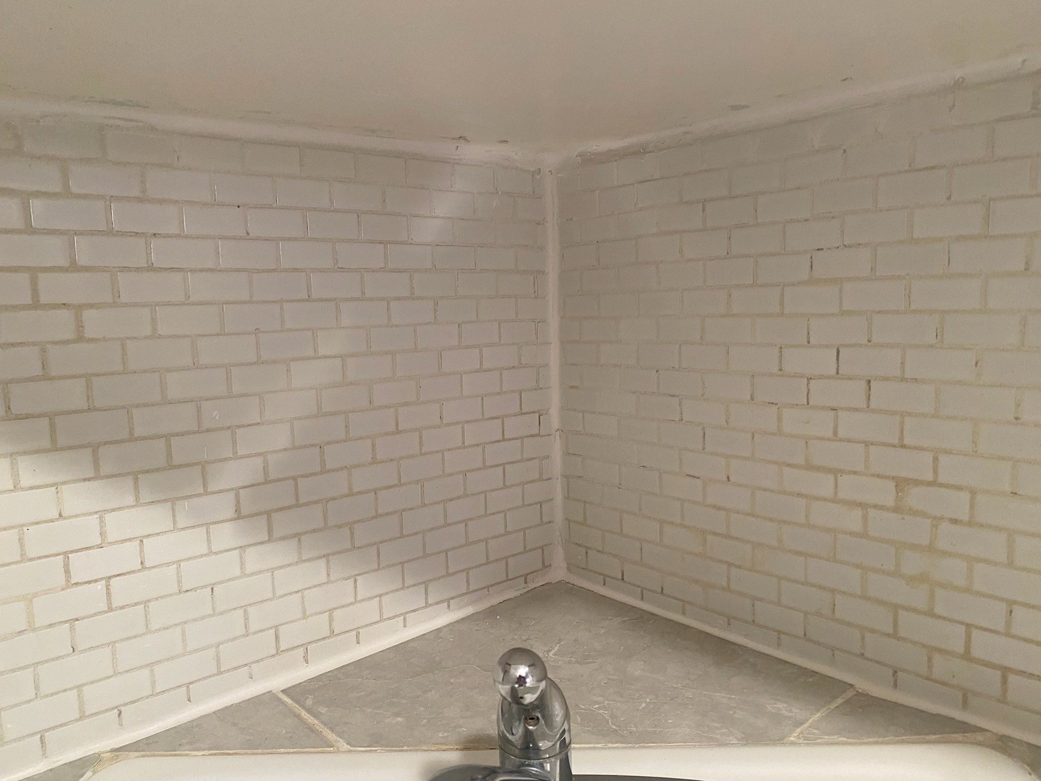 After the photo of the bathroom tile was refreshed. Clean grout lines and sealed edges in this Upper East Side (UES) unit.