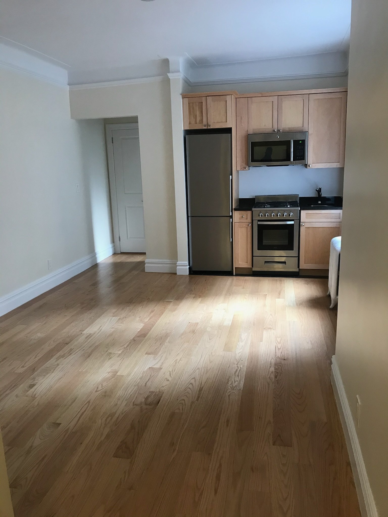 Floor blending and corner cleanup in this open-plan West Village unit. Smooth transitions, no harsh sanding needed.