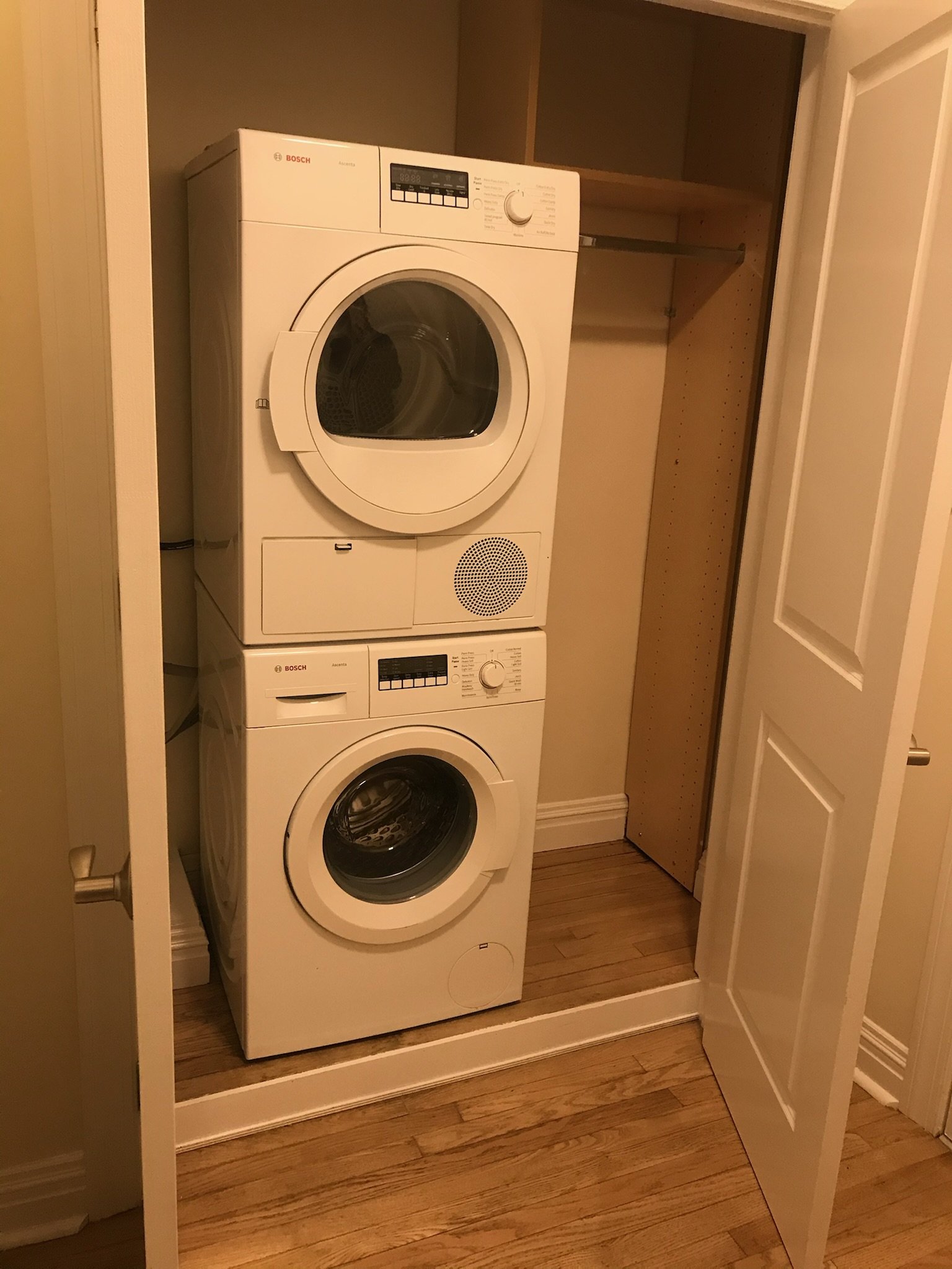 The closet was repurposed for a washer and dryer installation. Custom shelf and rod cut to fit clean and practical, West Village style.