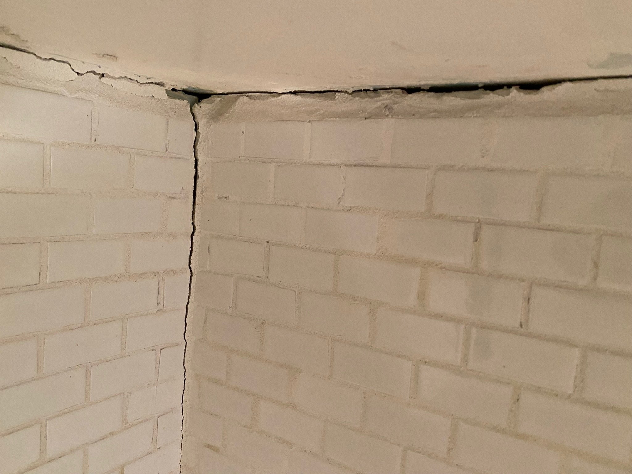Before photo of major wall crack near the ceiling. Structural repairs are in progress in this Upper East Side (UES) home.