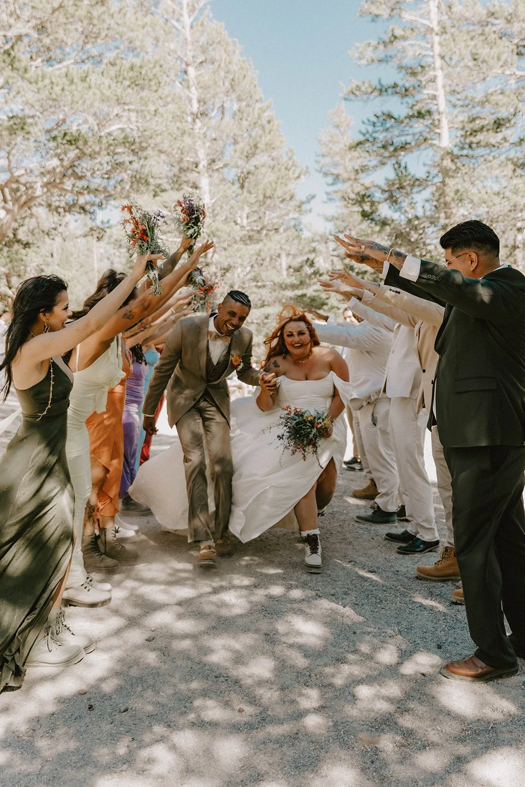 Bride and groom running through tunnel at Mammoth Lakes wedding — Southern California wedding photographer Tesla Rae Photo based in Huntington Beach