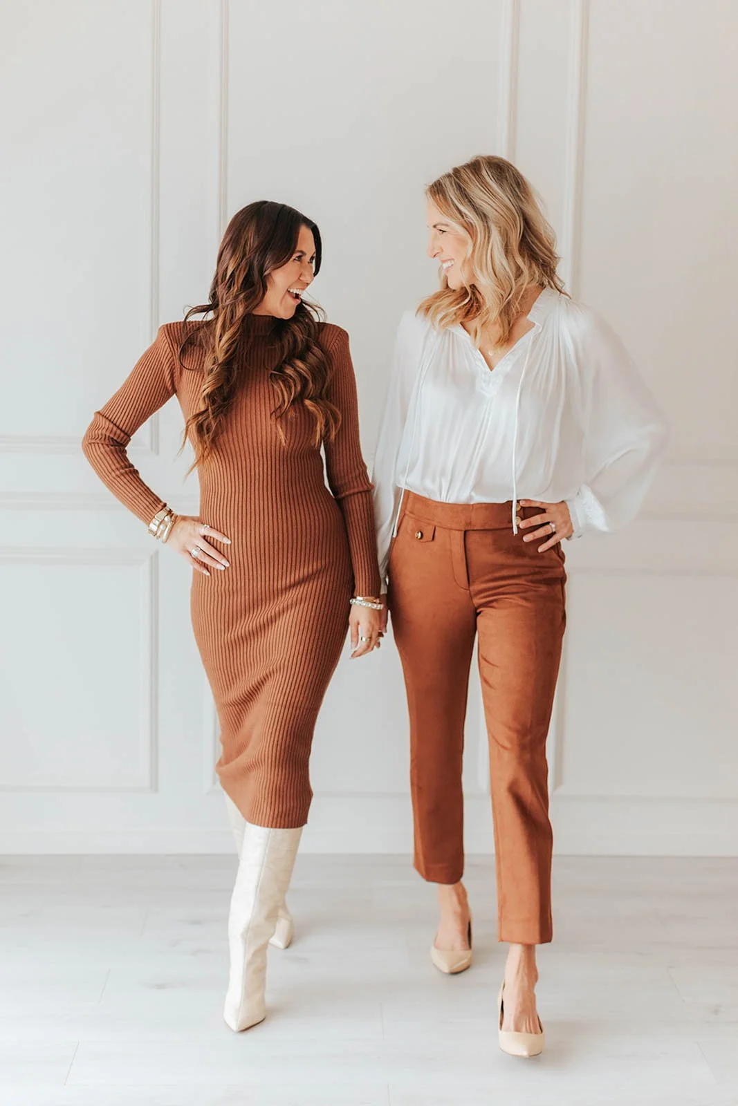 Two stylish women walking together in a bright natural light studio during a modern branding photography session in Orange County, California. Warm, candid imagery perfect for personal brands, entrepreneurs, and lifestyle businesses.