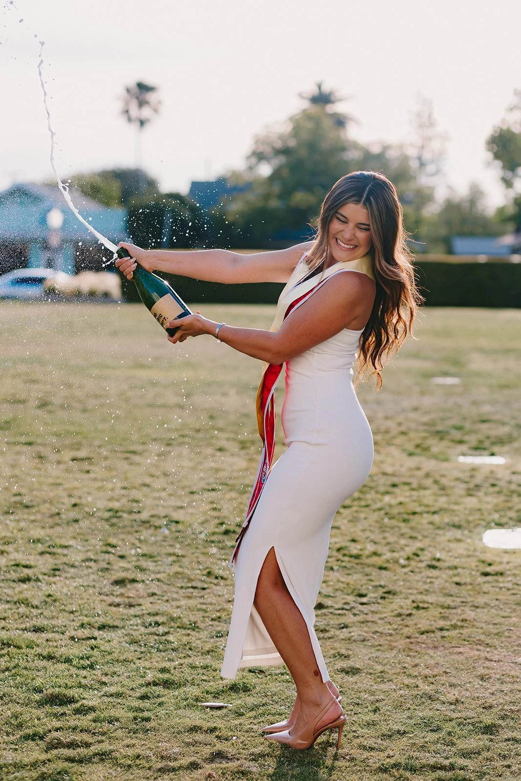 Grad celebrating with lifestyle portraits on Chapman University campus in Orange — Best graduation photographers in Orange County for authentic moments — Captured by Tesla Rae Photo