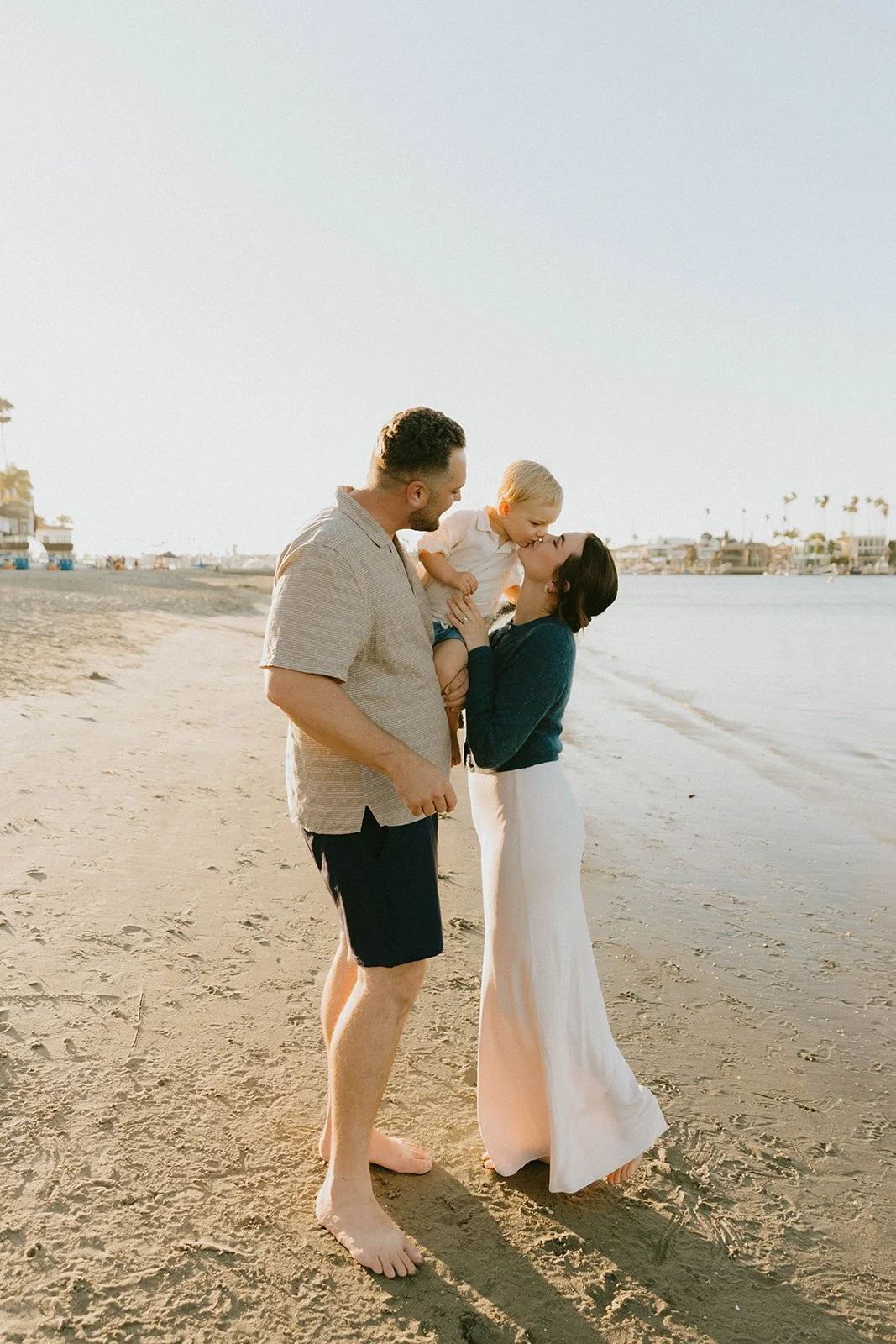 Carefree family laughing and playing at Huntington Beach — Best candid family photographers in Huntington Beach — Captured by Tesla Rae Photo