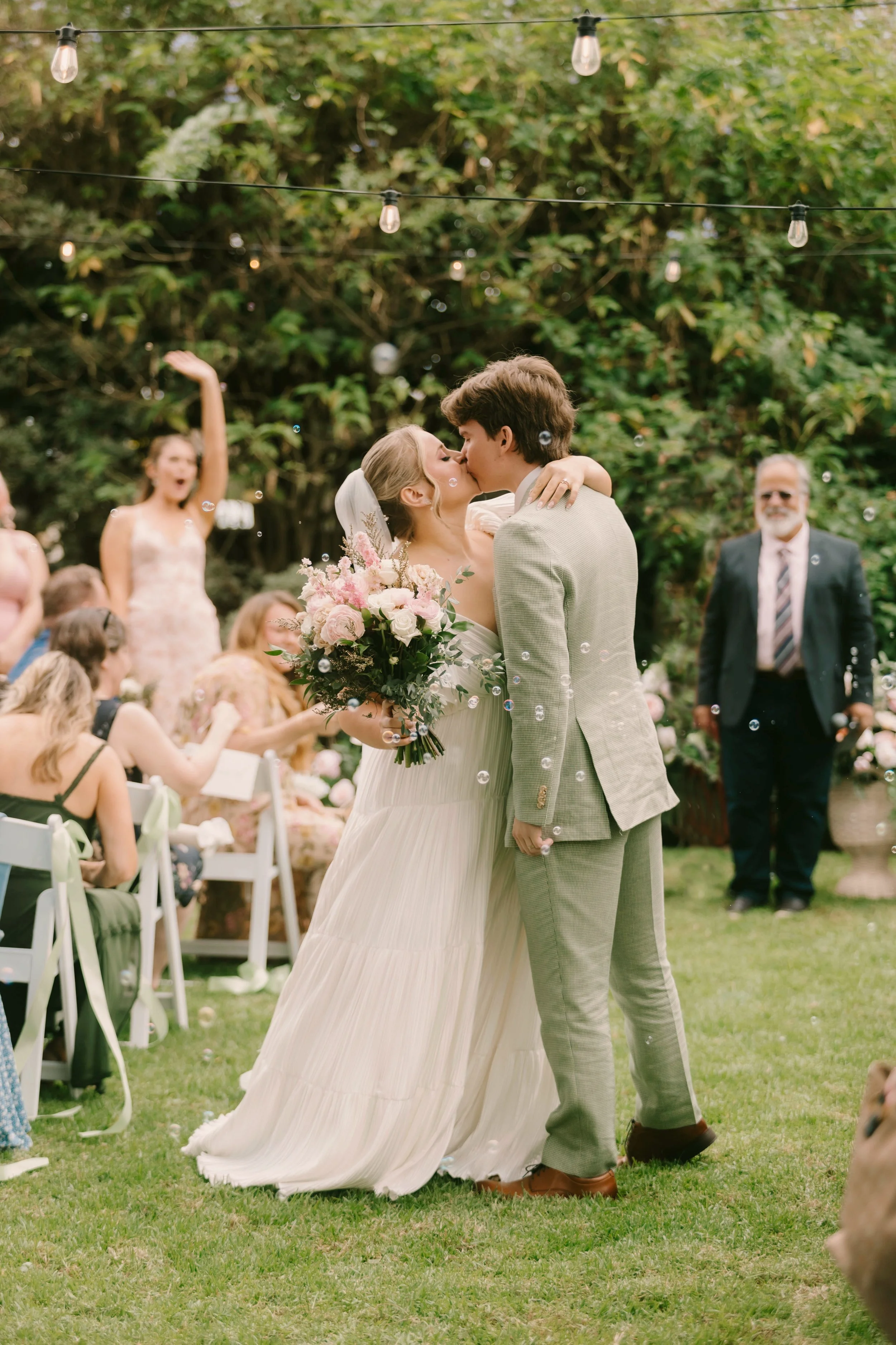 Bride and groom sharing their first kiss at The French Estate wedding in Orange, CA — Southern California wedding photographer Tesla Rae Photo based in Huntington Beach