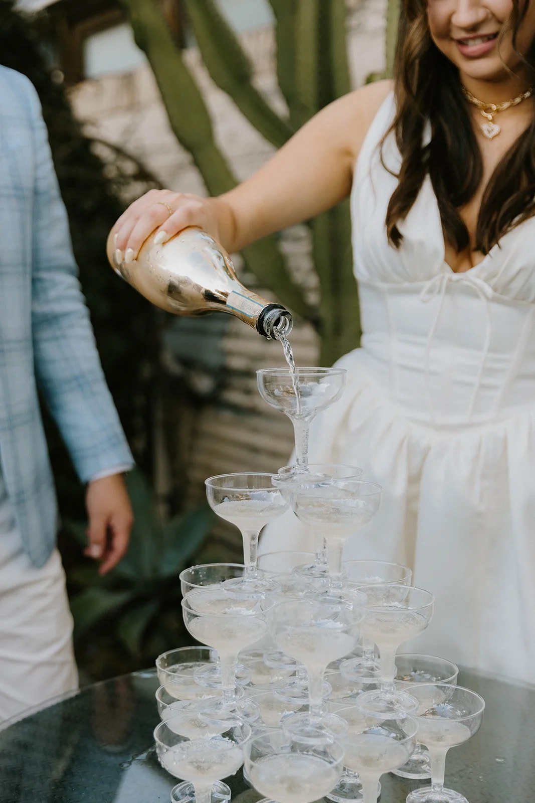 A couple pouring champagne on a champagne tower during couples engagement party at The Shindy in Costa Mesa— Orange County event photographer Tesla Rae Photo