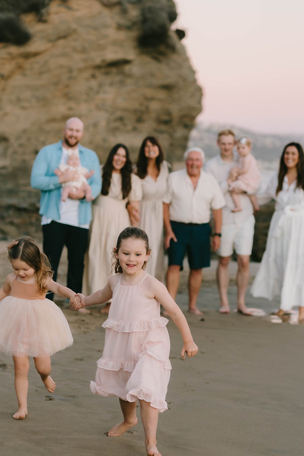 Carefree family laughing and playing during extended family session at Laguna Beach — Best candid family photographers in Laguna Beach — Captured by Tesla Rae Photo