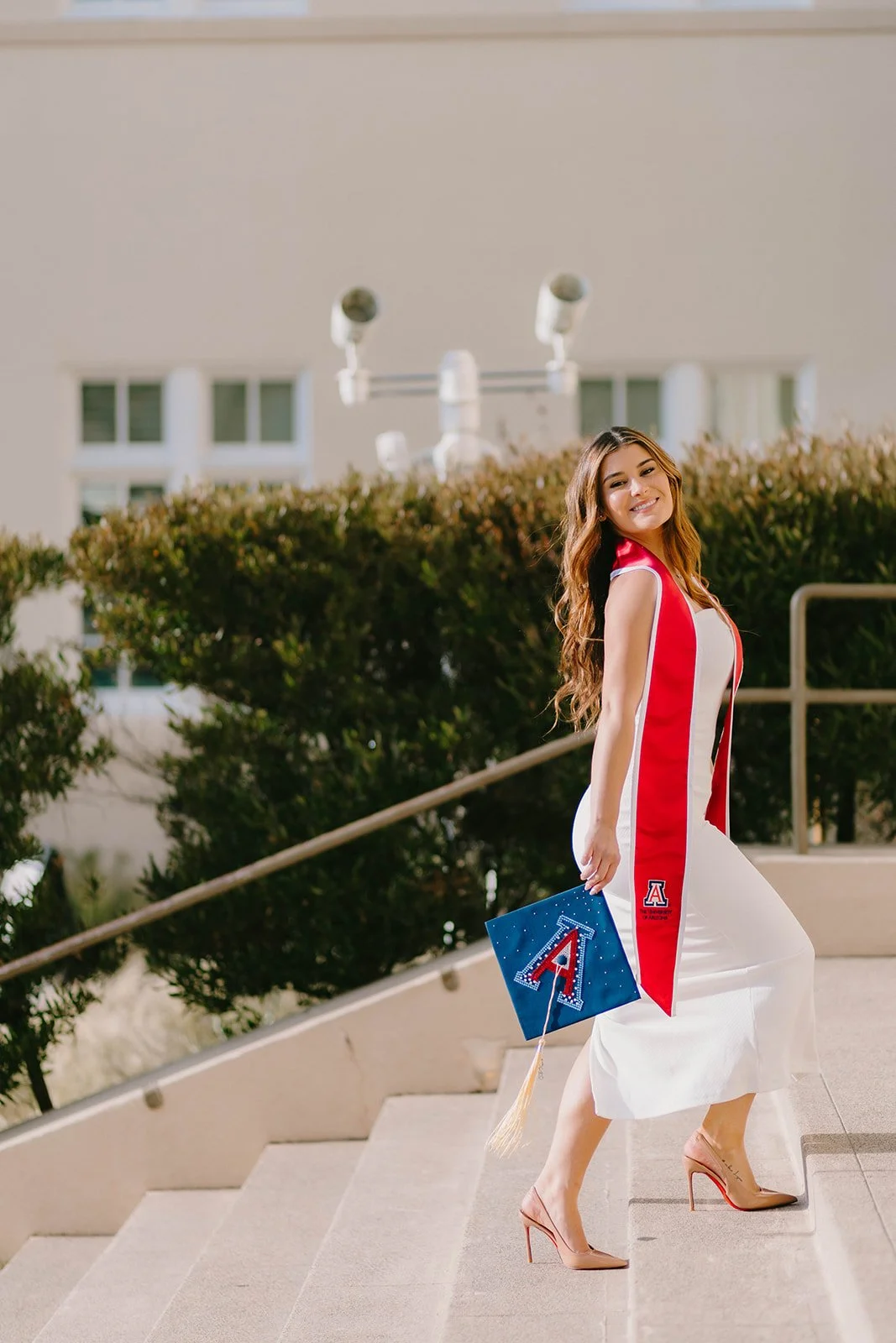 Grad celebrating with lifestyle portraits on Chapman University campus in Orange — Best graduation photographers in Orange County for authentic moments — Captured by Tesla Rae Photo