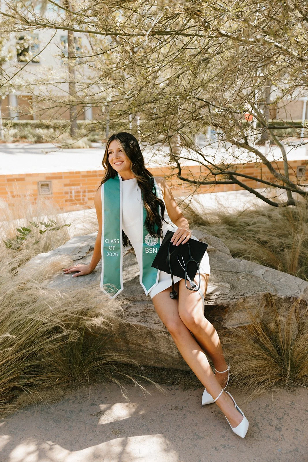 Grad celebrating with lifestyle portraits on Chapman University campus in Orange — Best graduation photographers in Orange County for authentic moments — Captured by Tesla Rae Photo