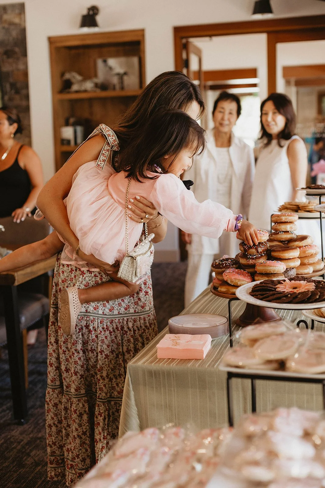 Little girl reaching for treats at upscale baby shower at Nellie Gail Ranch Clubhouse in Laguna Hills - Orange County event photographer Tesla Rae Photo