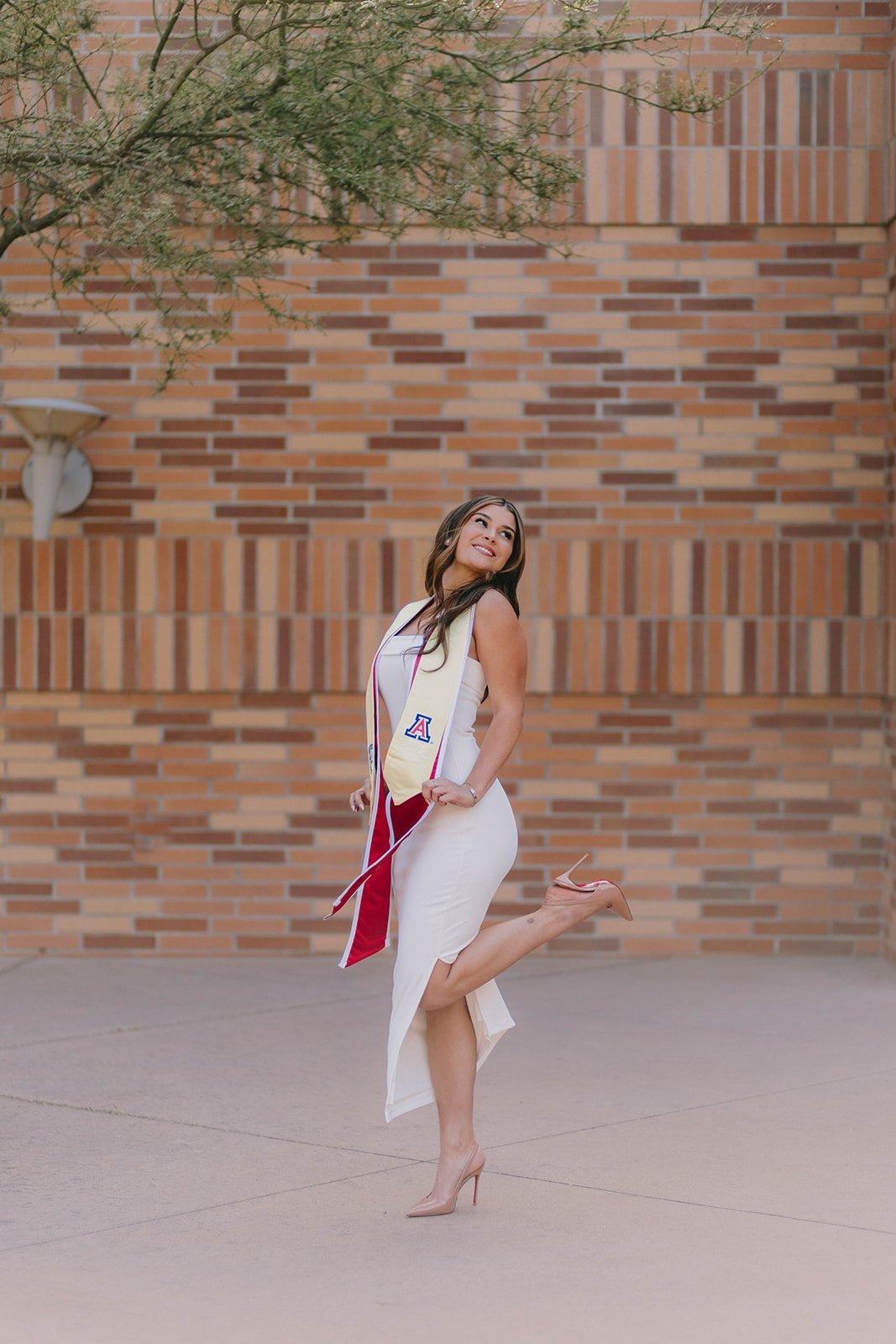 Grad celebrating with lifestyle portraits on Chapman University campus in Orange — Best graduation photographers in Orange County for authentic moments — Captured by Tesla Rae Photo