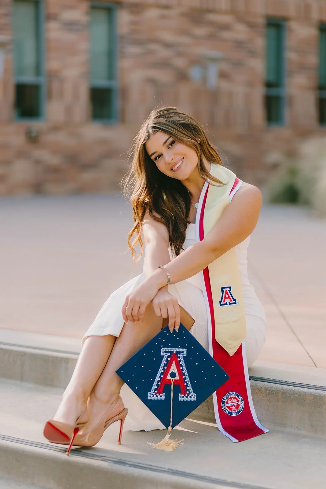 Grad celebrating with lifestyle portraits on Chapman University campus in Orange — Best graduation photographers in Orange County for authentic moments — Captured by Tesla Rae Photo