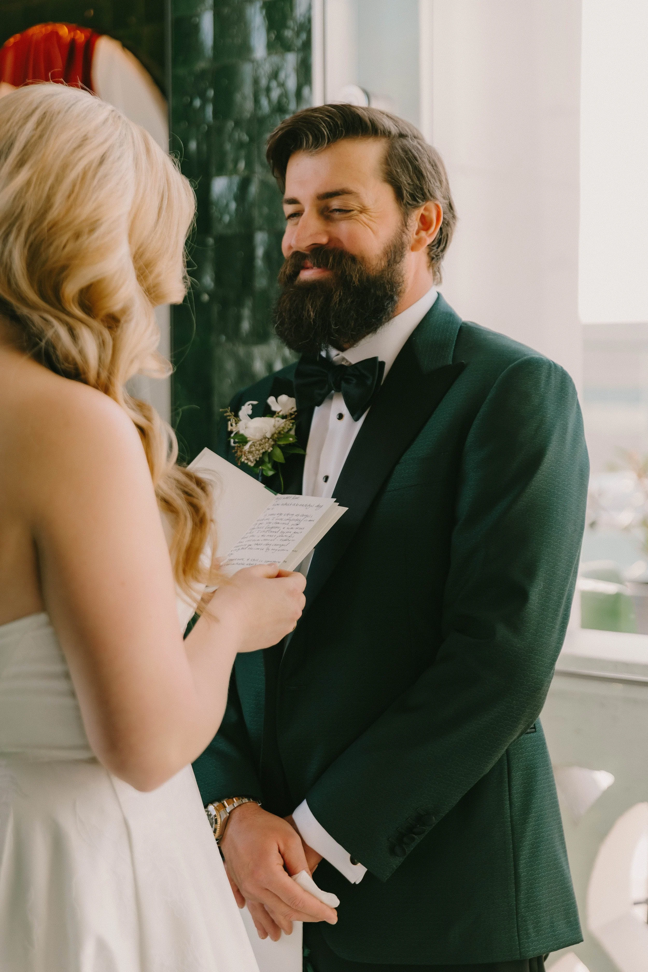 Bride and groom sharing an intimate first look and reading private vows at Fairmont Breakers Hotel in Long Beach — Southern California wedding photographer Tesla Rae Photo based in Huntington Beach