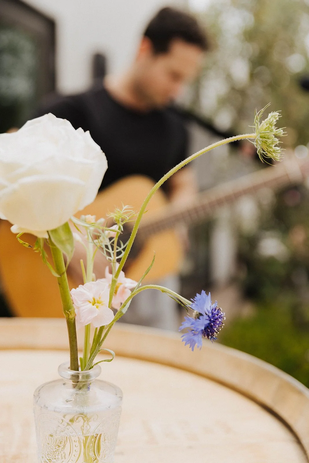 Live acoustic music during an intimate outdoor celebration in Southern California featuring elegant event details, florals, and candid elevated party photography.