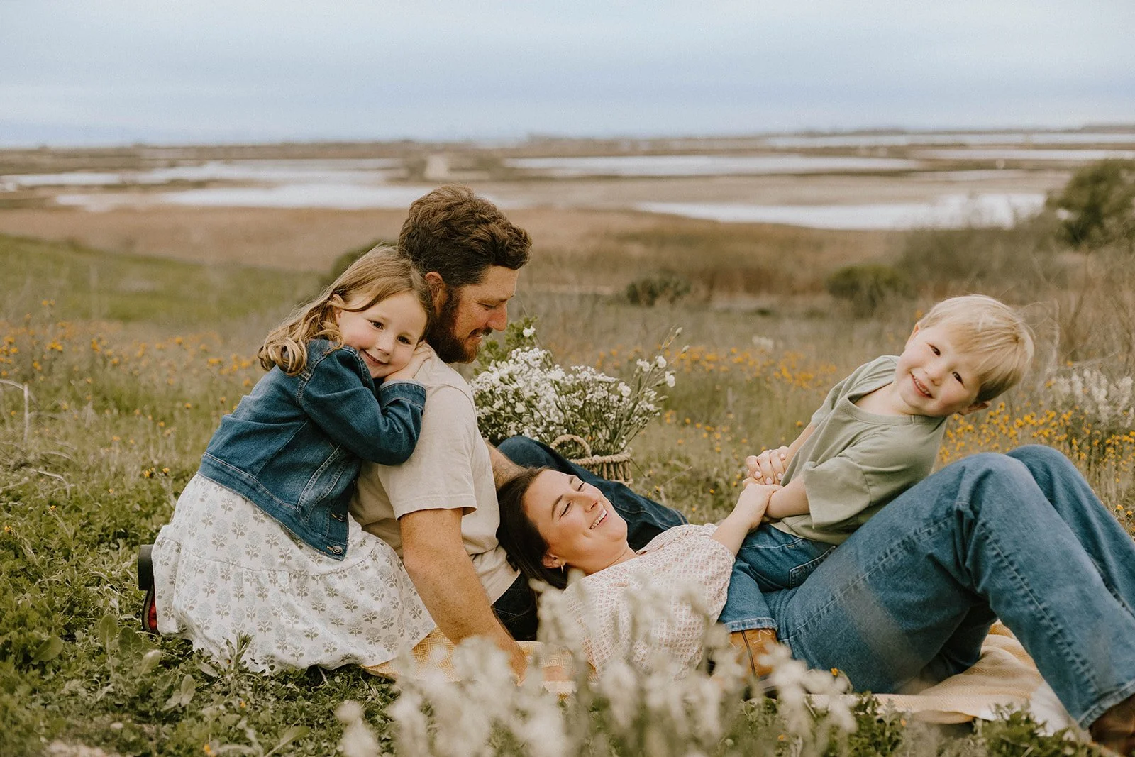 Carefree family laughing and playing at golden field in Huntington Beach — Best candid family photographers in Huntington Beach — Captured by Tesla Rae Photo