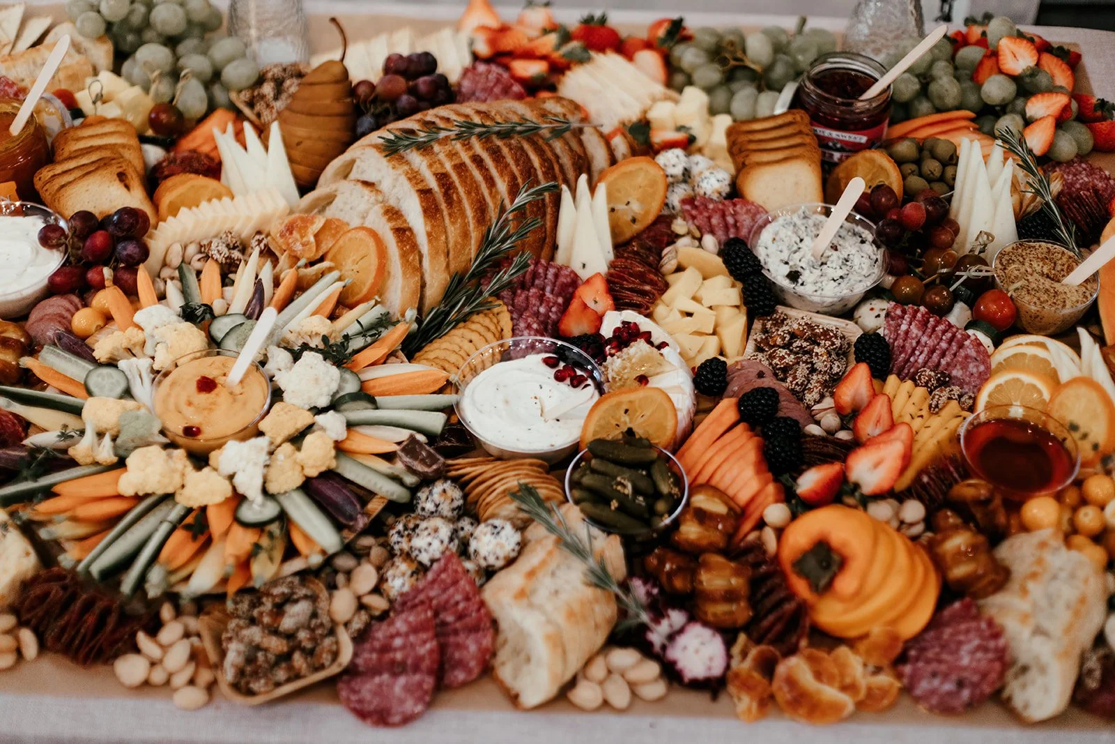 Luxurious table setting details and charcuterie, grazing table at upscale baby shower at Fullerton Arboretum.