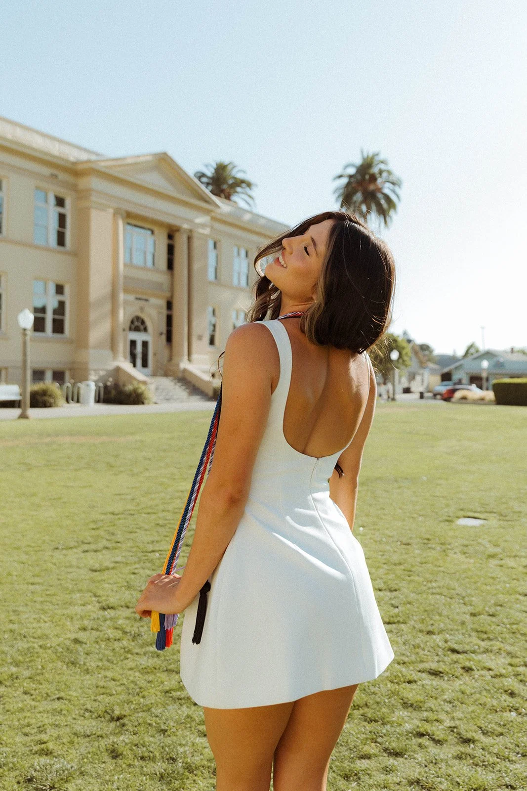 Grad celebrating with lifestyle portraits on Chapman University campus in Orange — Best graduation photographers in Orange County for authentic moments — Captured by Tesla Rae Photo