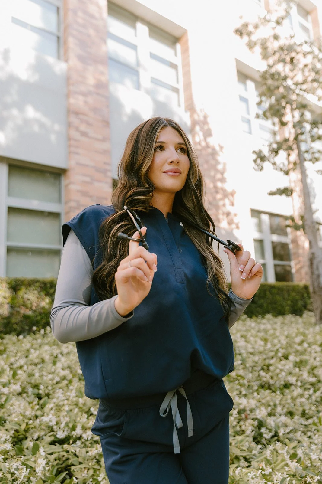 Grad celebrating with lifestyle portraits on Chapman University campus in Orange — Best graduation photographers in Orange County for authentic moments — Captured by Tesla Rae Photo