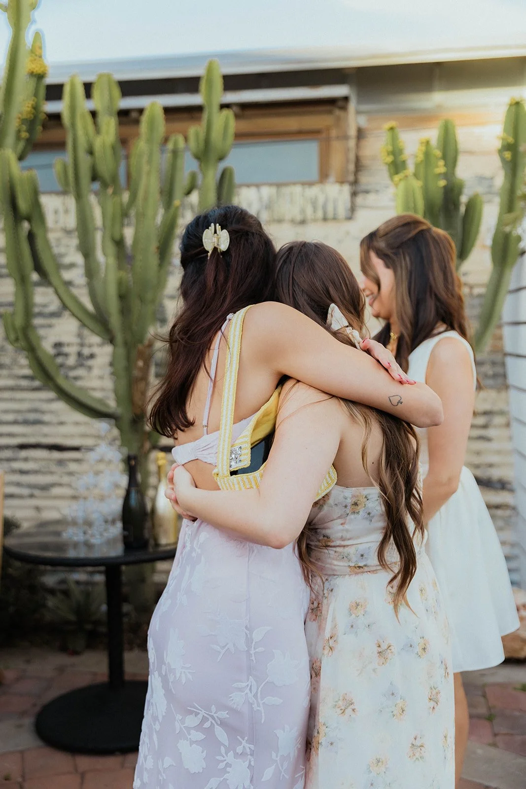 Friends hugging during couples engagement party at The Shindy in Costa Mesa— Orange County event photographer Tesla Rae Photo