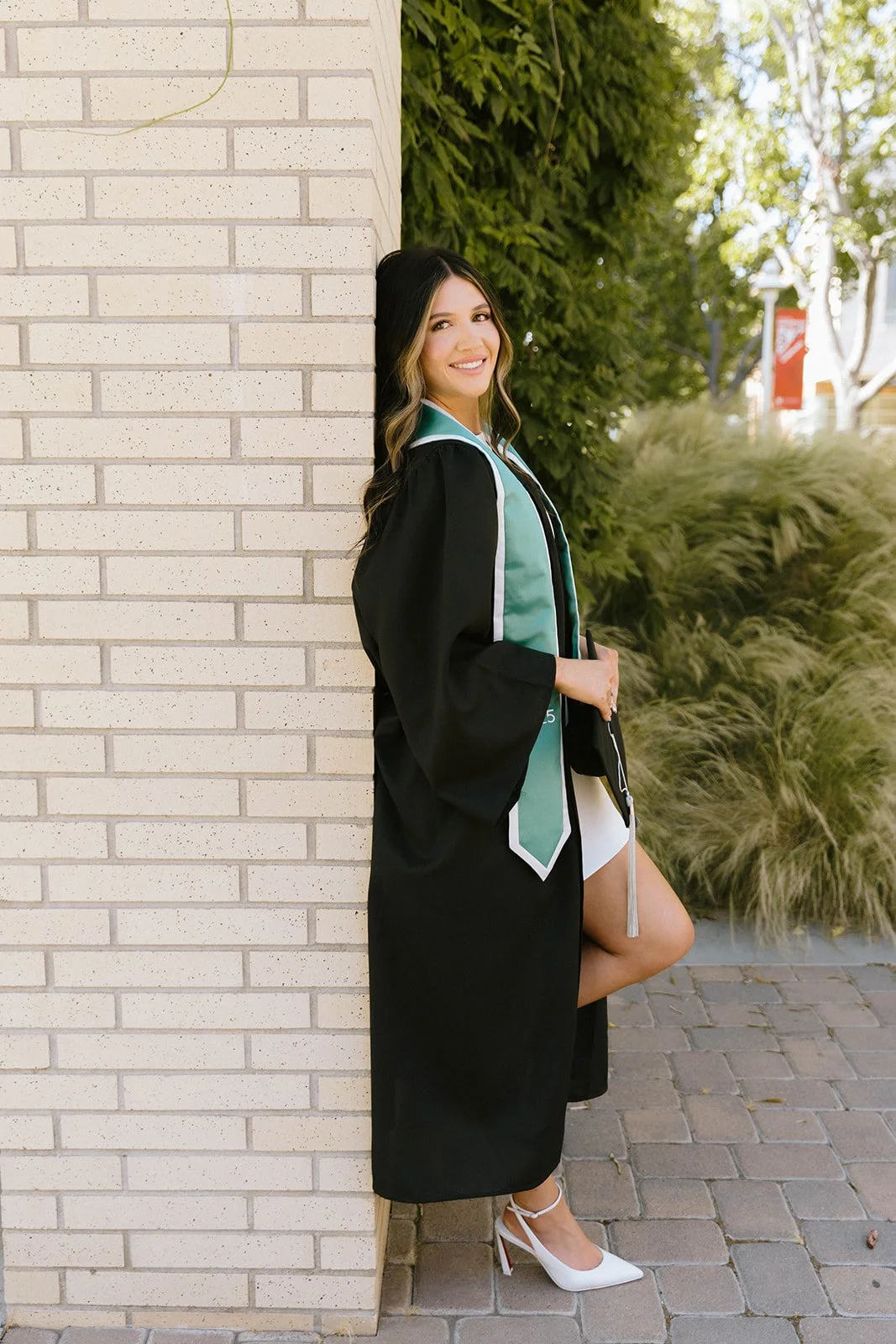 Grad celebrating with lifestyle portraits on Chapman University campus in Orange — Best graduation photographers in Orange County for authentic moments — Captured by Tesla Rae Photo