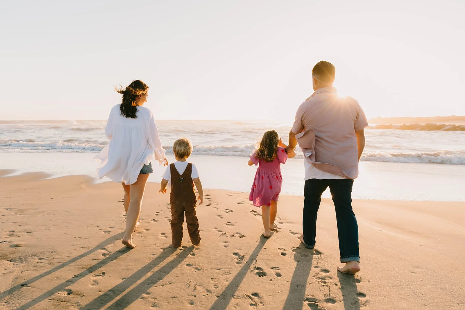 Carefree family laughing and playing at Huntington Beach — Best candid family photographers in Huntington Beach — Captured by Tesla Rae Photo