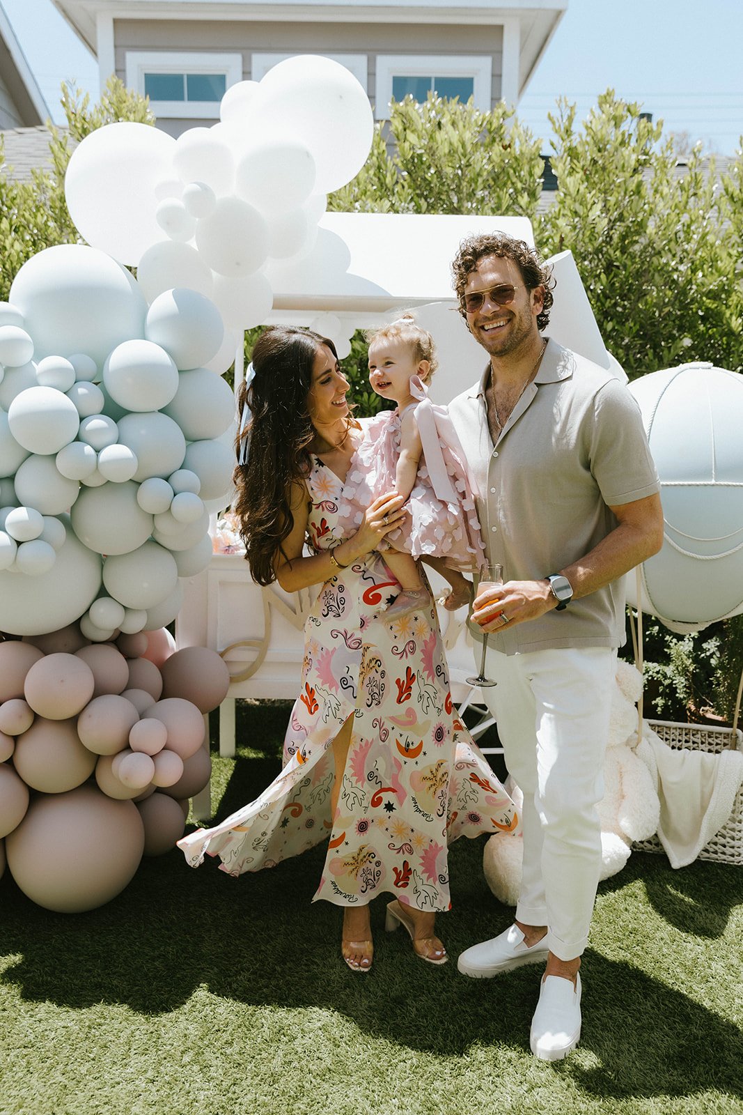 Couple posing with their baby at first birthday  in Newport Beach — Orange County event photographer Tesla Rae Photo