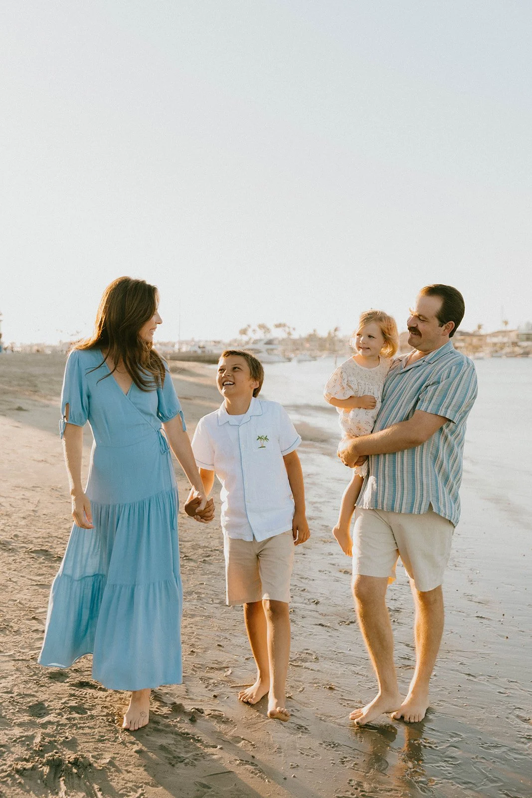 Carefree family laughing and playing at Huntington Beach — Best candid family photographers in Huntington Beach — Captured by Tesla Rae Photo