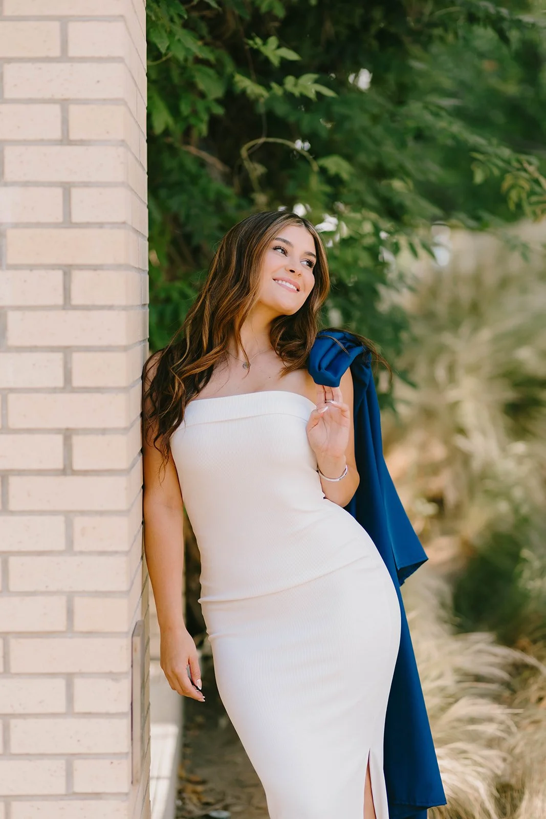 Grad celebrating with lifestyle portraits on Chapman University campus in Orange — Best graduation photographers in Orange County for authentic moments — Captured by Tesla Rae Photo
