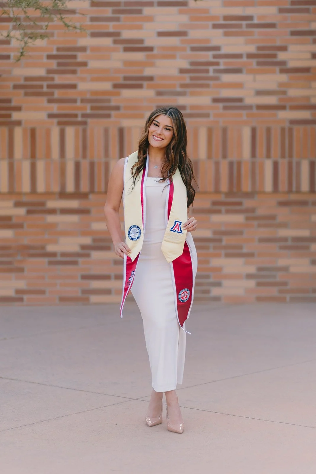 Grad celebrating with lifestyle portraits on Chapman University campus in Orange — Best graduation photographers in Orange County for authentic moments — Captured by Tesla Rae Photo