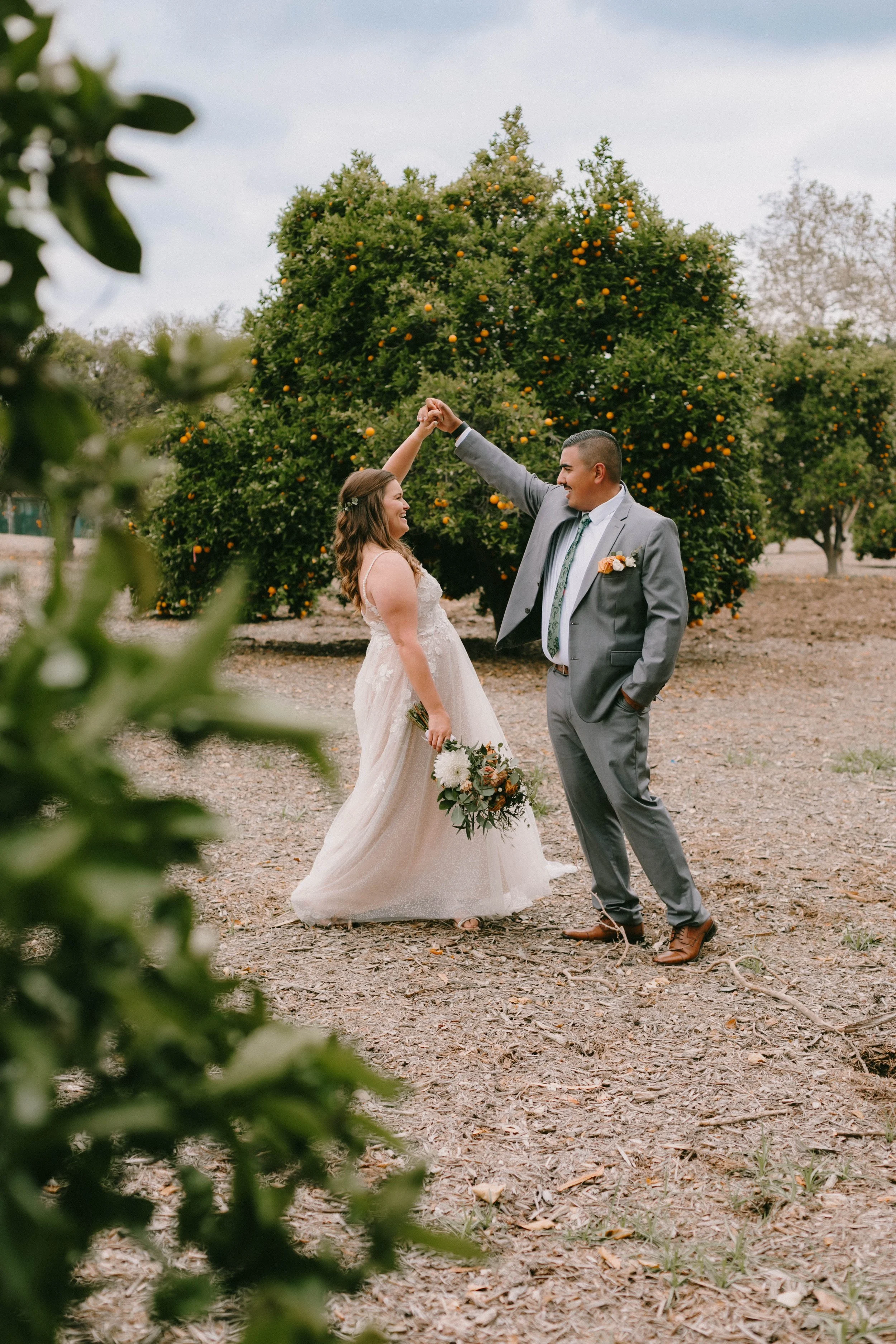 Bride and Groom twirling and dancing on their wedding day in Orange County.