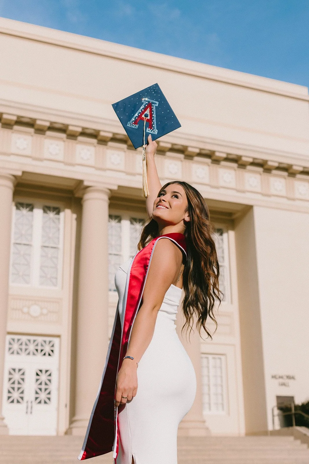 Grad celebrating with lifestyle portraits on Chapman University campus in Orange — Best graduation photographers in Orange County for authentic moments — Captured by Tesla Rae Photo