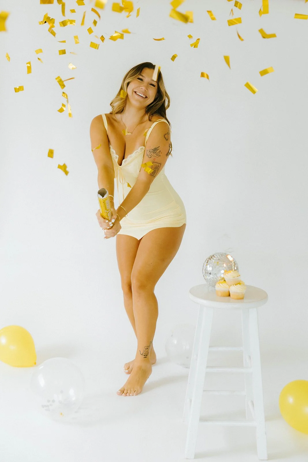 Celebratory, lifestyle birthday portraits of girl popping confetti and smiling in Huntington Beach, natural light studio — Best brand photographers in Huntington Beach — Captured by Tesla Rae Photo