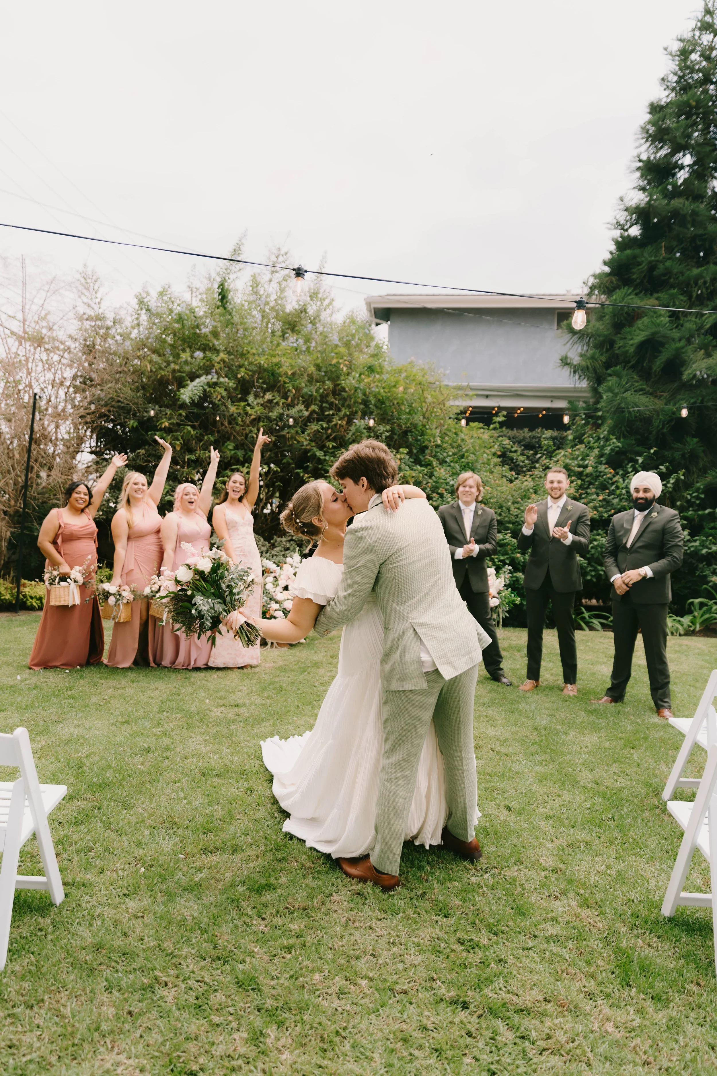 Bride and groom sharing their first kiss at The French Estate wedding in Orange, CA — Southern California wedding photographer Tesla Rae Photo based in Huntington Beach