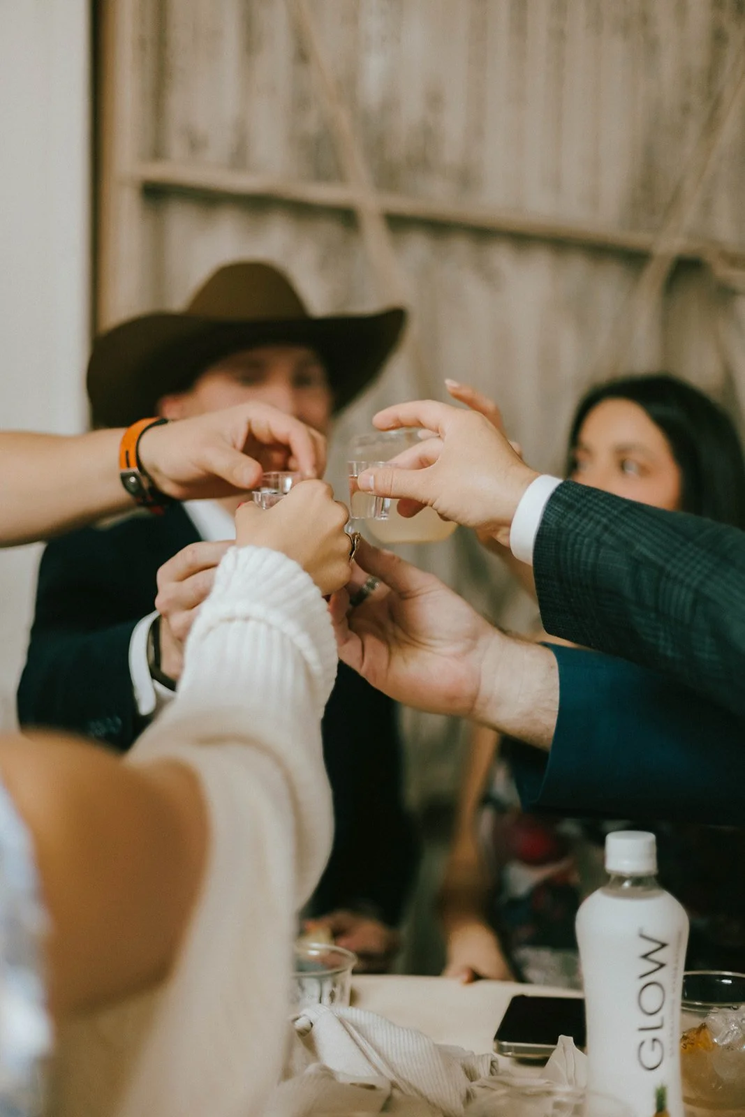 A group of people raising glasses in a toast at a gathering or celebration.