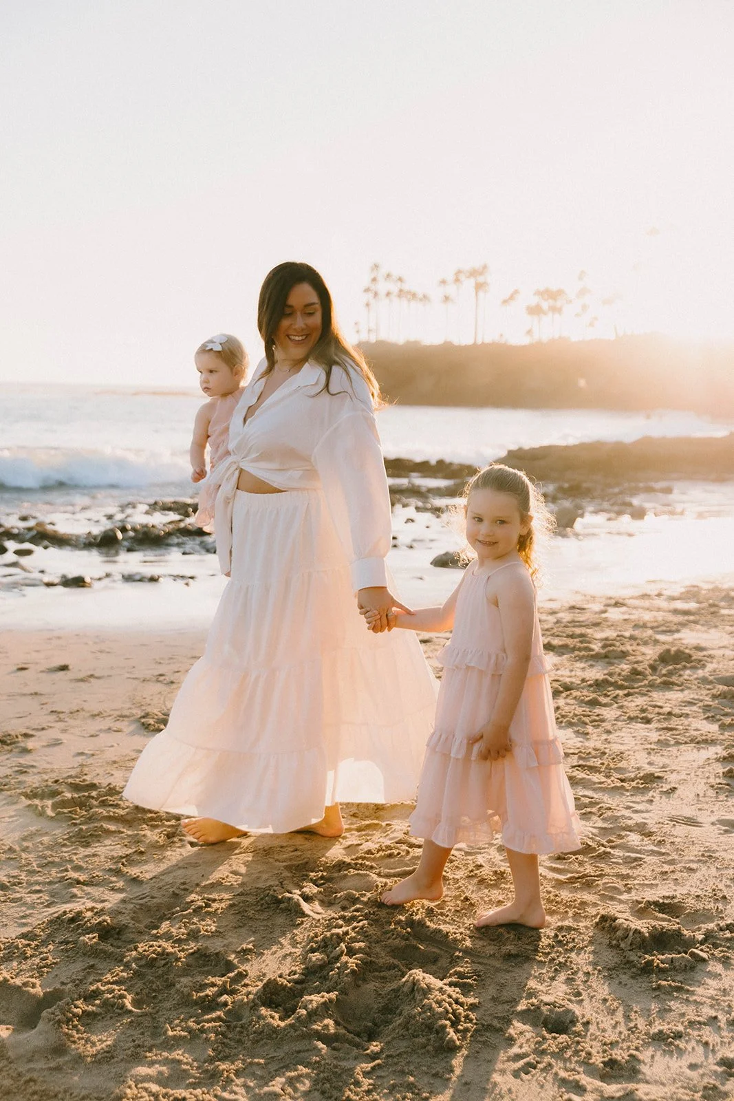 Carefree family laughing and playing at Laguna Beach — Best candid family photographers in Laguna Beach — Captured by Tesla Rae Photo