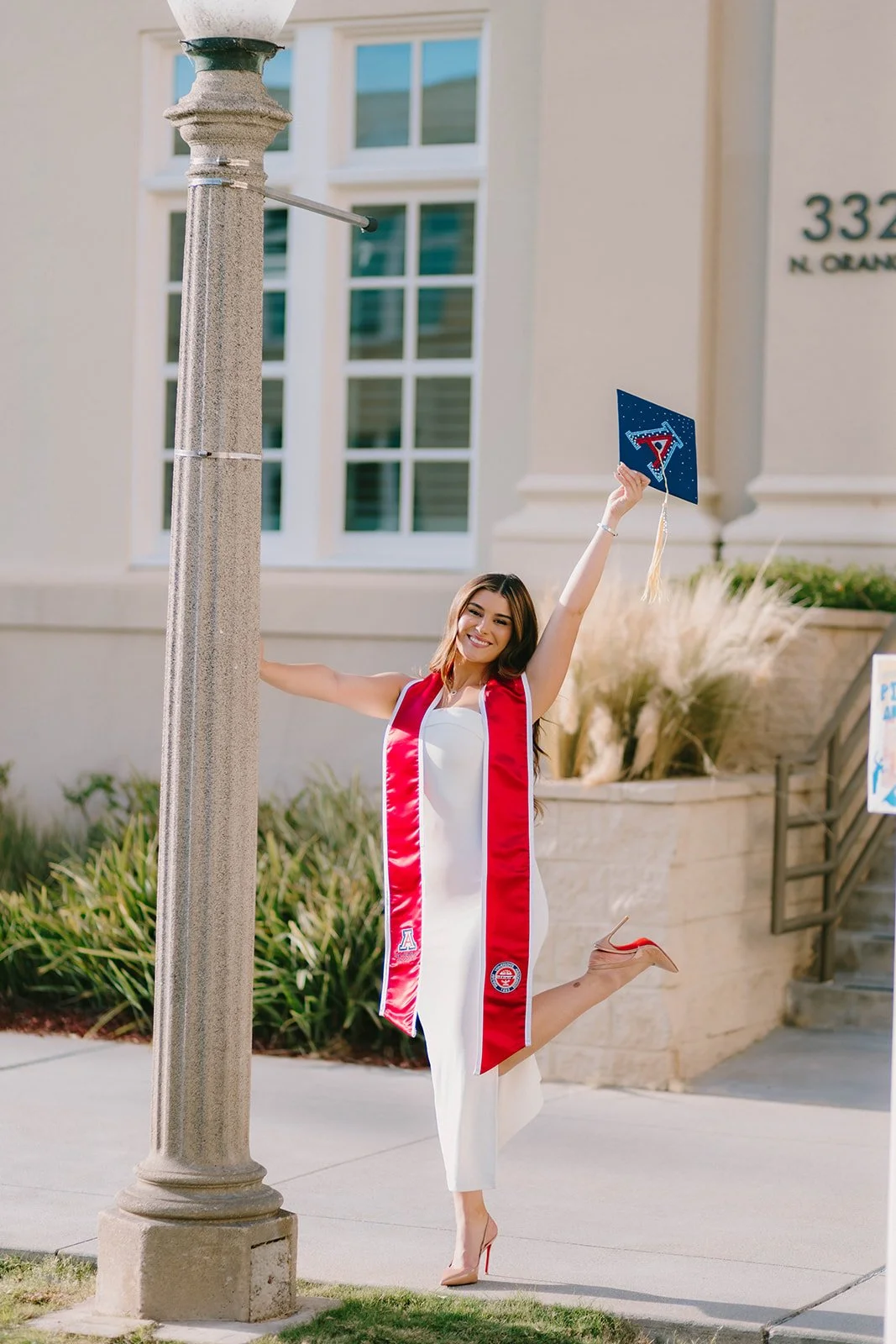 Grad celebrating with lifestyle portraits on Chapman University campus in Orange — Best graduation photographers in Orange County for authentic moments — Captured by Tesla Rae Photo