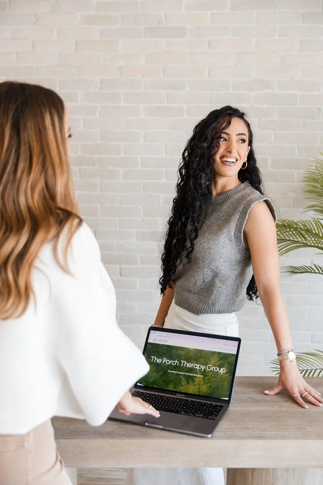 Personal branding photography session in Orange County featuring female entrepreneurs in a clean modern studio space with authentic business lifestyle imagery.