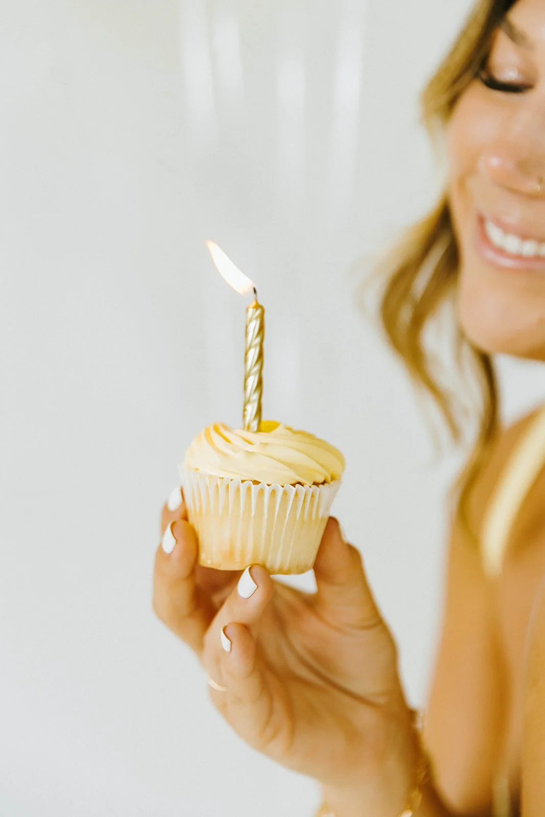Celebratory, lifestyle birthday portraits of girl holding birthday cupcake with birthday candle in Huntington Beach, natural light studio — Best brand photographers in Huntington Beach — Captured by Tesla Rae Photo