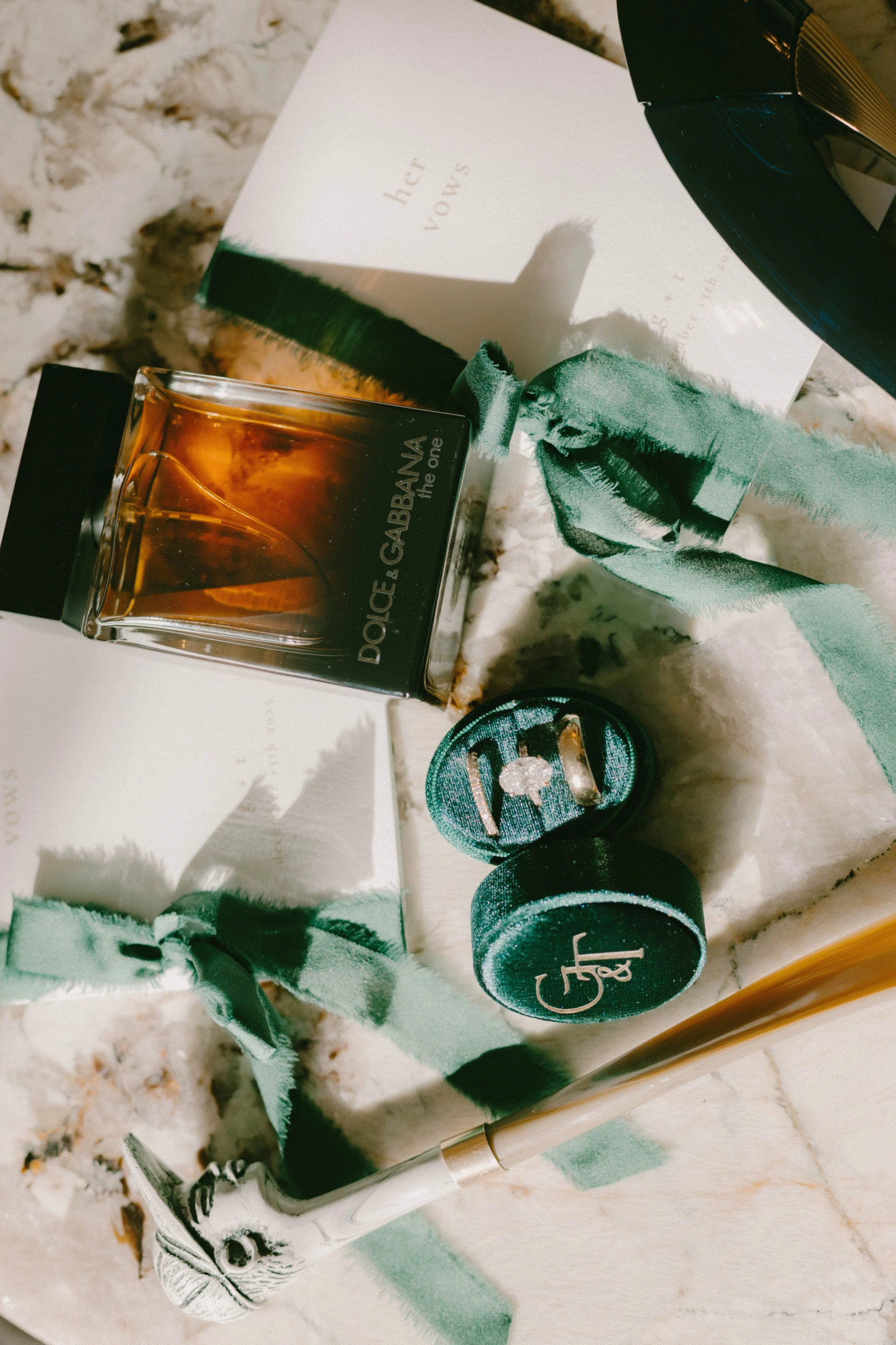 Bridal flat lay details featuring wedding rings, invitations, and cologne at Long Beach wedding — Long Beach wedding photographer Tesla Rae Photo