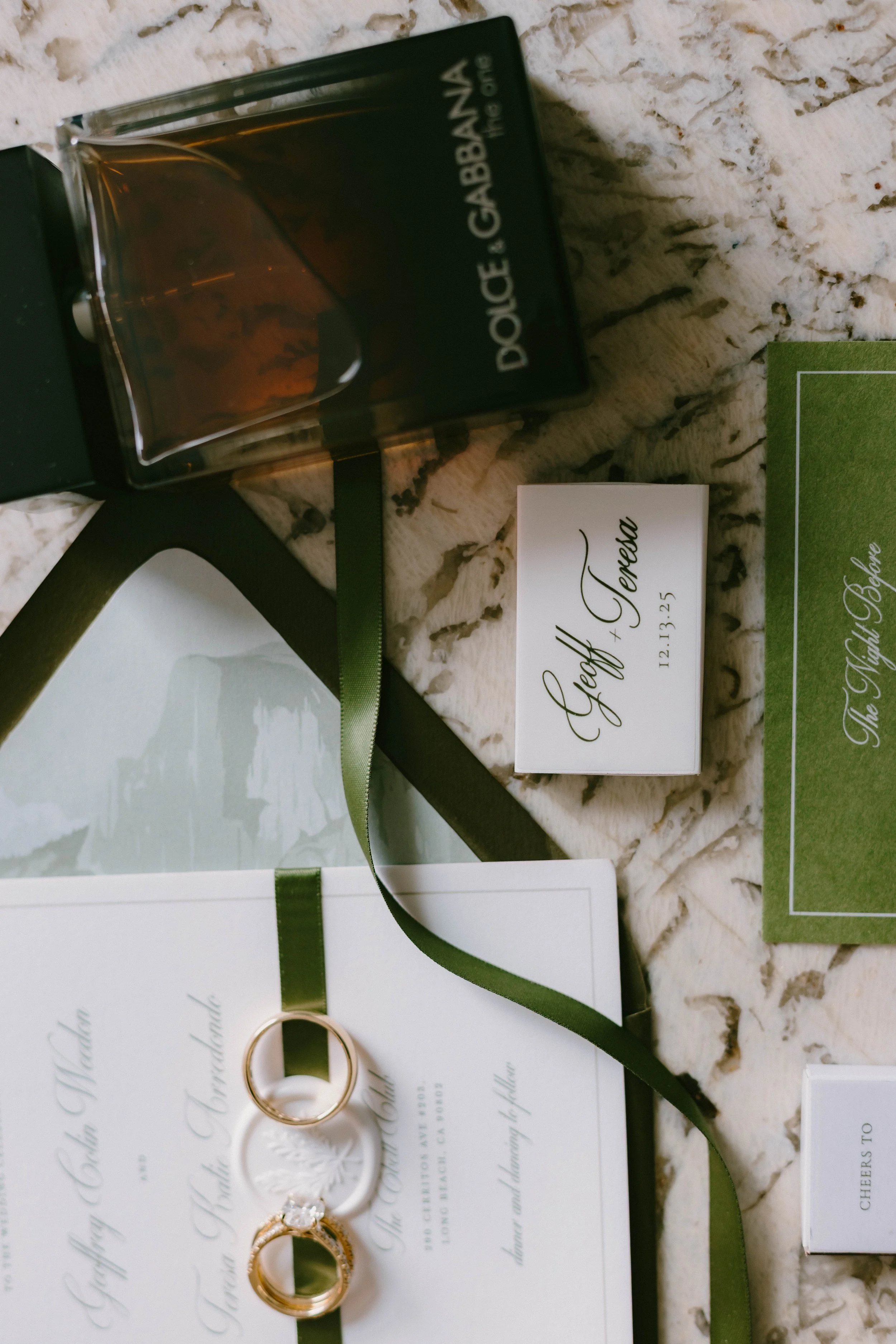 Bridal flat lay details featuring wedding rings, invitations, and cologne at Long Beach wedding — Long Beach wedding photographer Tesla Rae Photo