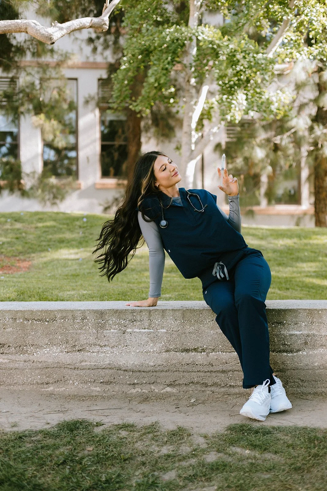 Grad celebrating with lifestyle portraits on Chapman University campus in Orange — Best graduation photographers in Orange County for authentic moments — Captured by Tesla Rae Photo
