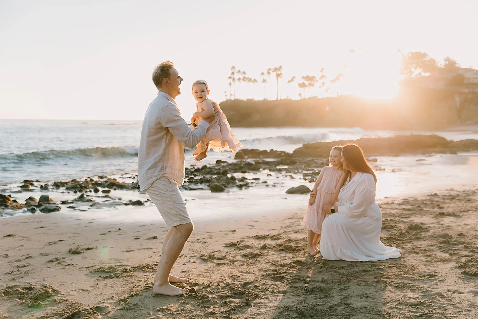 Carefree family laughing and playing at Laguna Beach — Best candid family photographers in Laguna Beach — Captured by Tesla Rae Photo