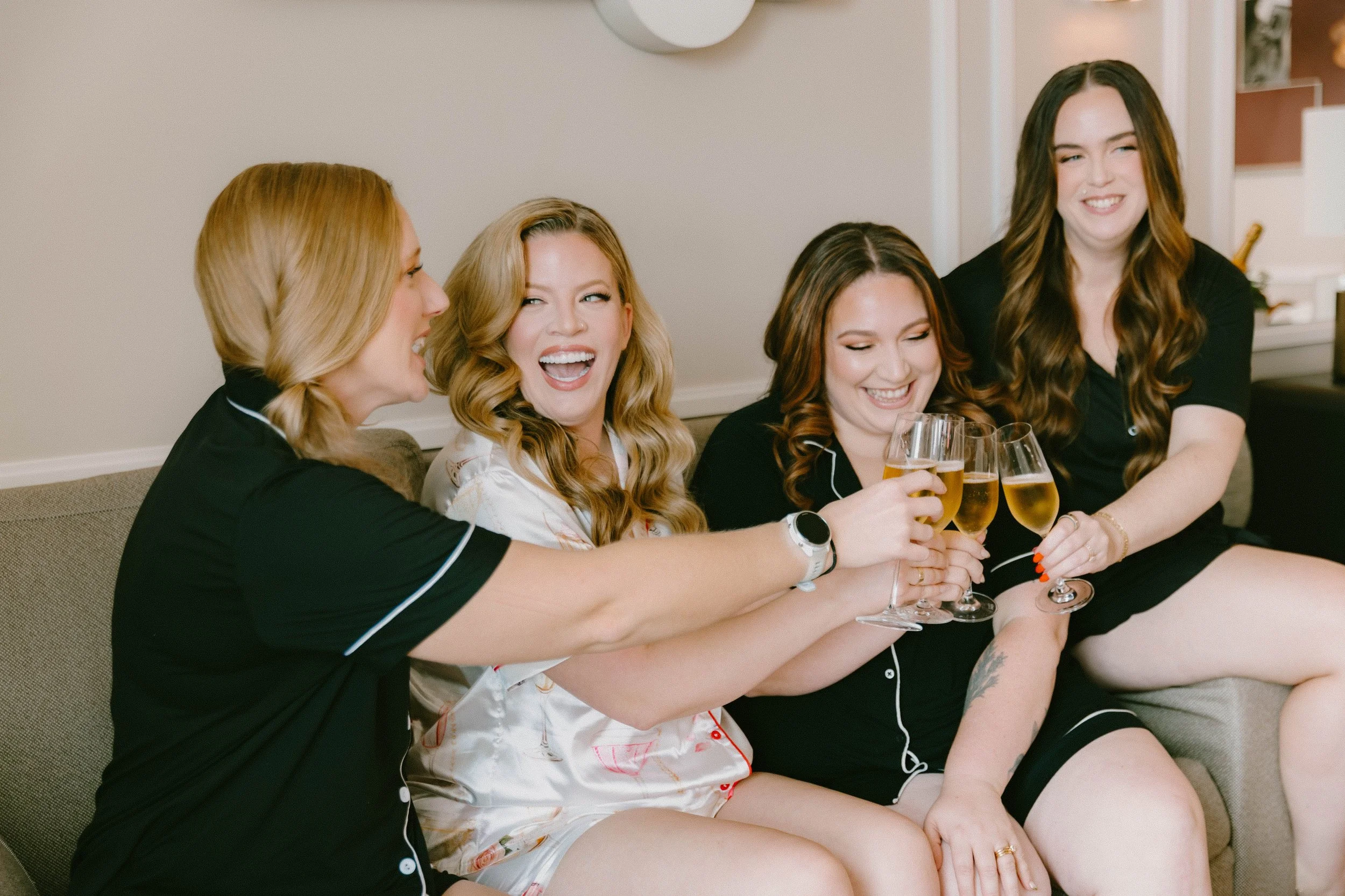 
Bride and bridesmaids toasting champagne at Fairmont Breakers Hotel Long Beach — Long Beach wedding photographer Tesla Rae Photo