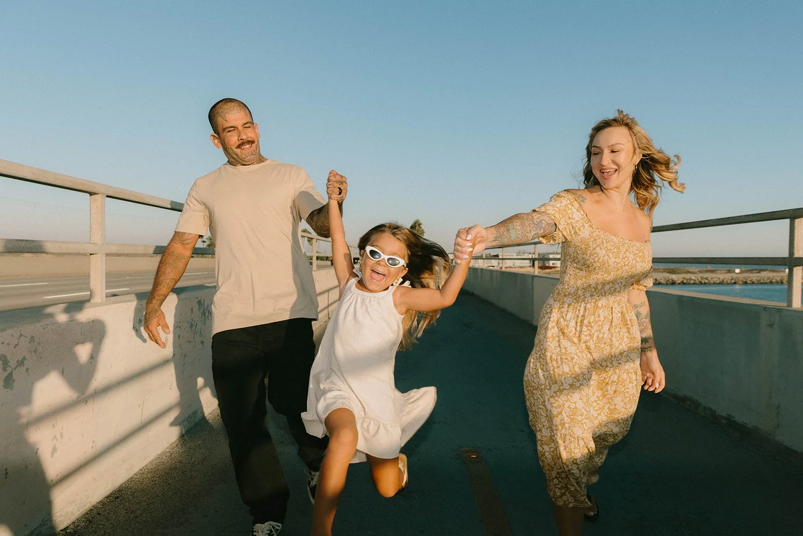 Carefree family laughing and playing at Huntington Beach — Best candid family photographers in Huntington Beach — Captured by Tesla Rae Photo