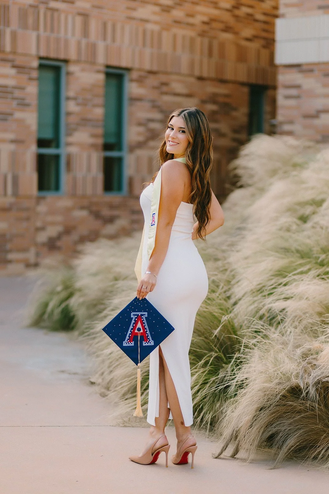 Grad celebrating with lifestyle portraits on Chapman University campus in Orange — Best graduation photographers in Orange County for authentic moments — Captured by Tesla Rae Photo