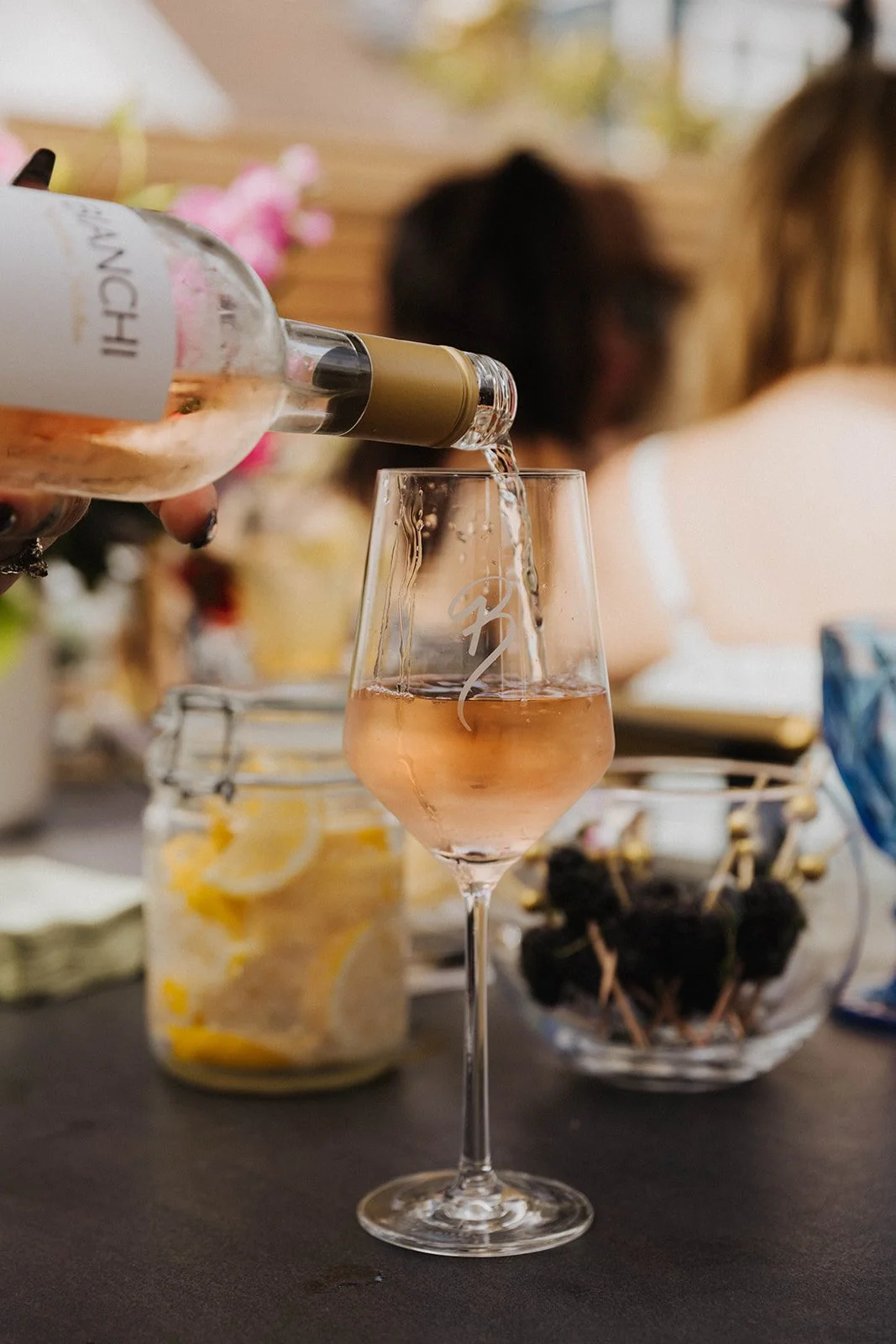 Wine being poured during intimate ladies' networking event at Bianchi Laguna Beach— Luxury event photographer Tesla Rae Photo based in Southern California