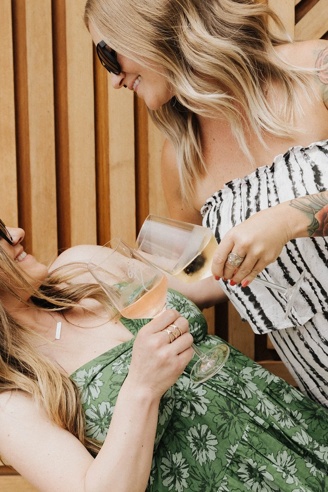 Women celebrating with champagne during a stylish birthday gathering in Orange County, California captured with candid event photography and elevated lifestyle storytelling details.