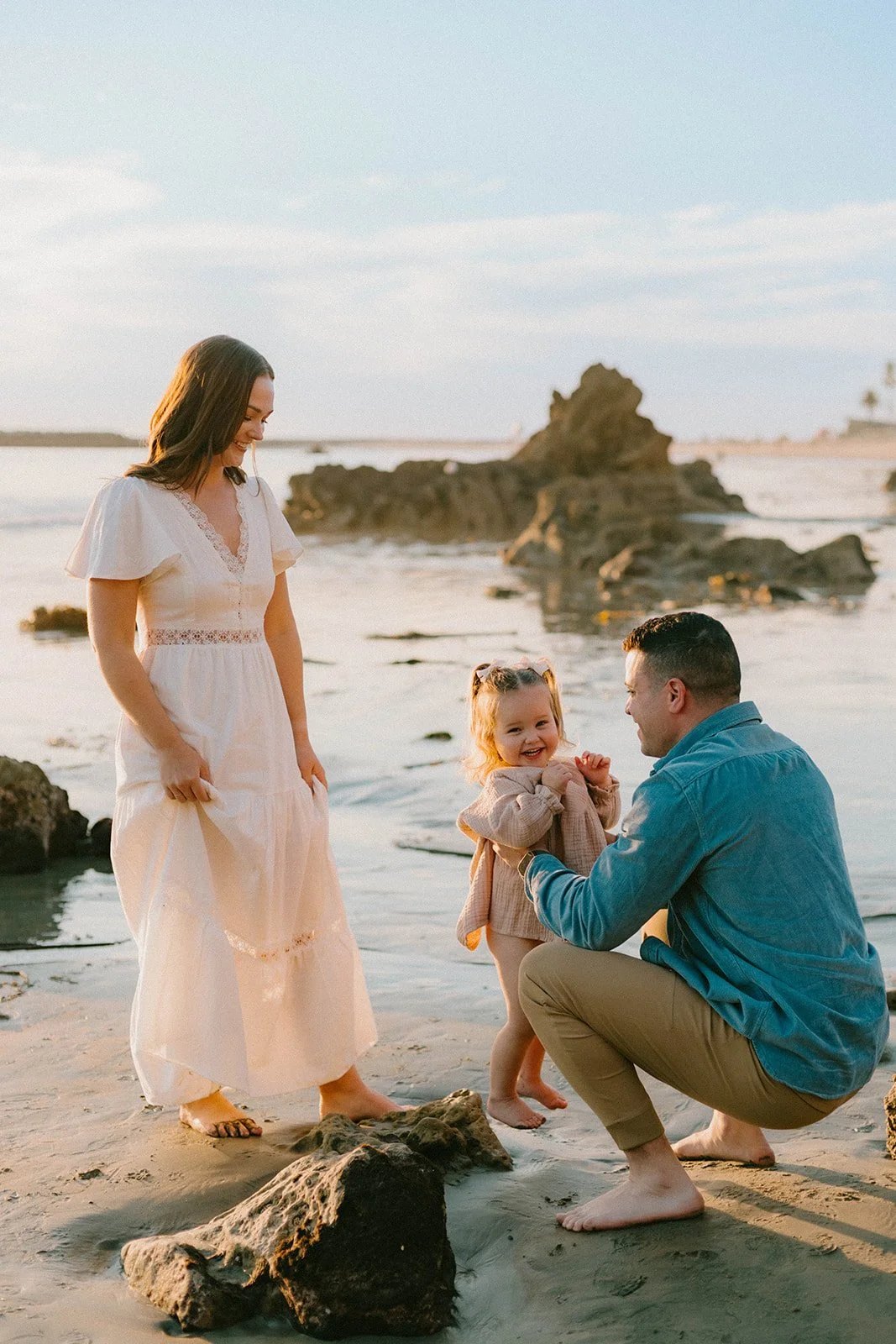 Carefree family laughing and playing at Laguna Beach — Best candid family photographers in Laguna Beach — Captured by Tesla Rae Photo