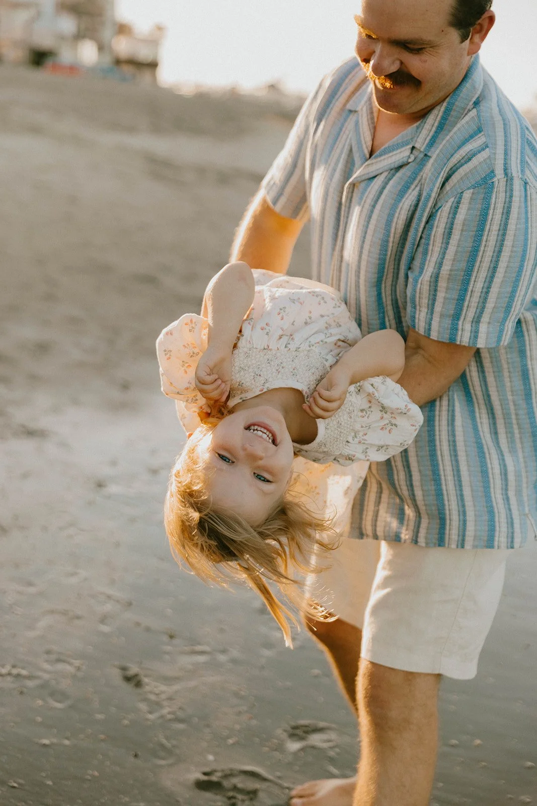 Carefree family laughing and playing at Huntington Beach — Best candid family photographers in Huntington Beach — Captured by Tesla Rae Photo