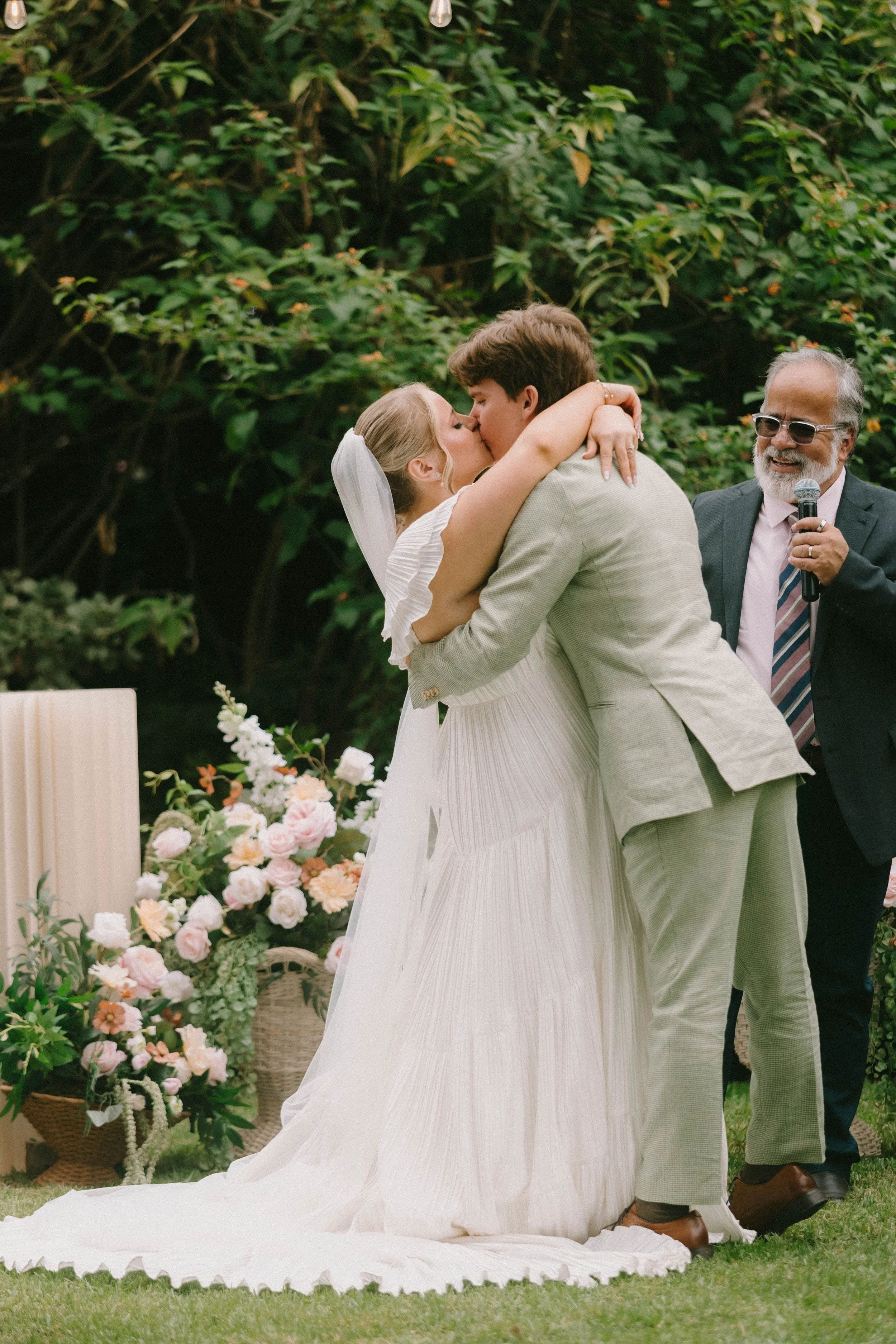 Bride and groom sharing their first kiss at The French Estate wedding in Orange, CA — Southern California wedding photographer Tesla Rae Photo based in Huntington Beach